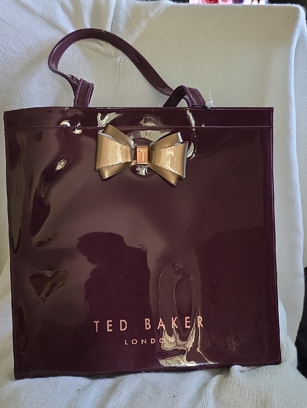 Ted Baker Glossy Plum Patent Tote with Gold Bow Accent